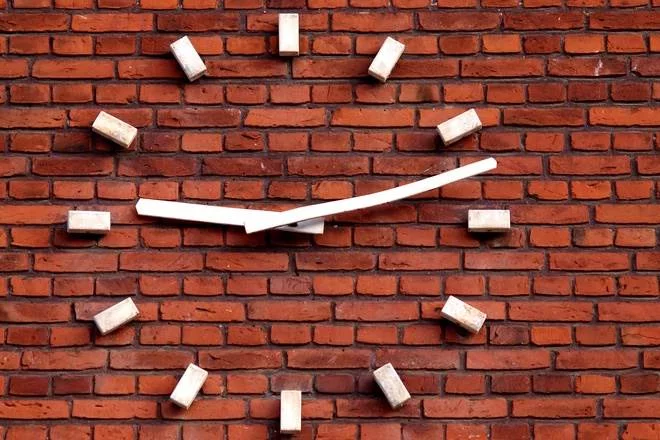 clock-on-a-red-brick-wall-1412425.jpg
